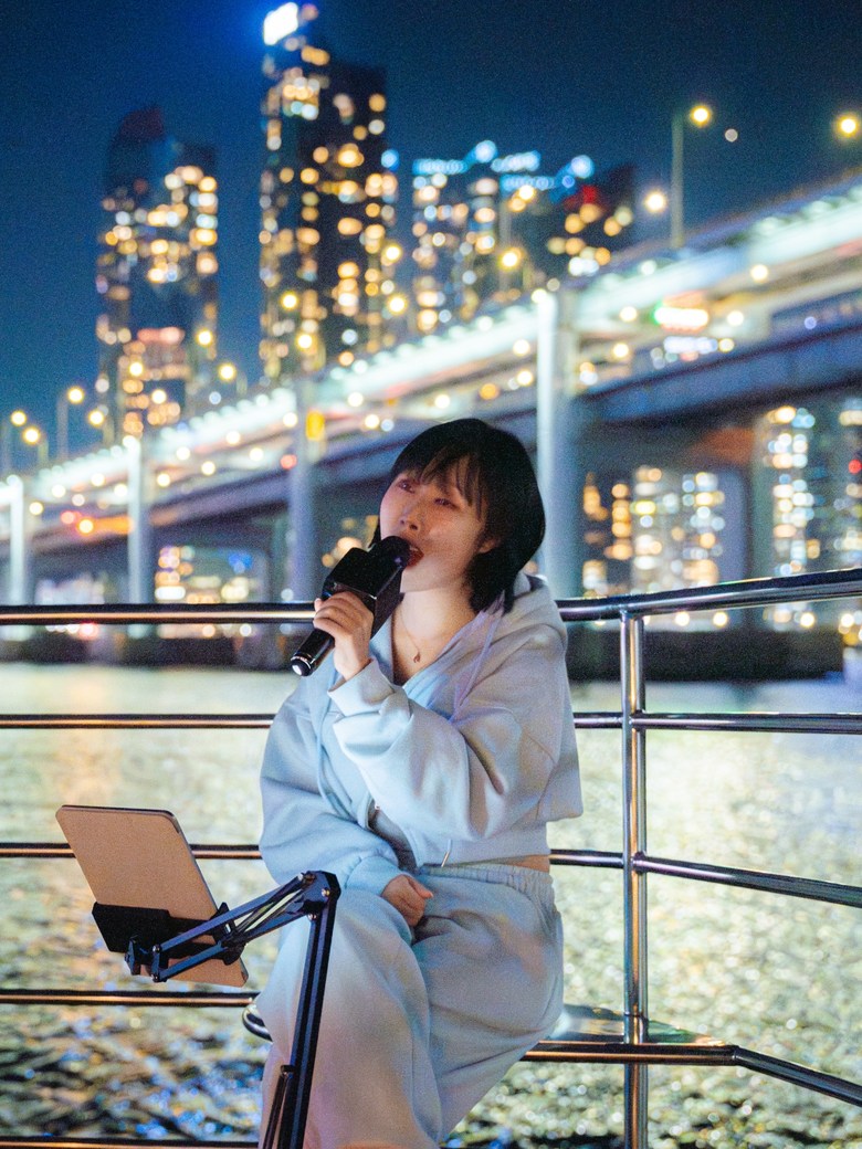 A guest standing in front of Marine City at night