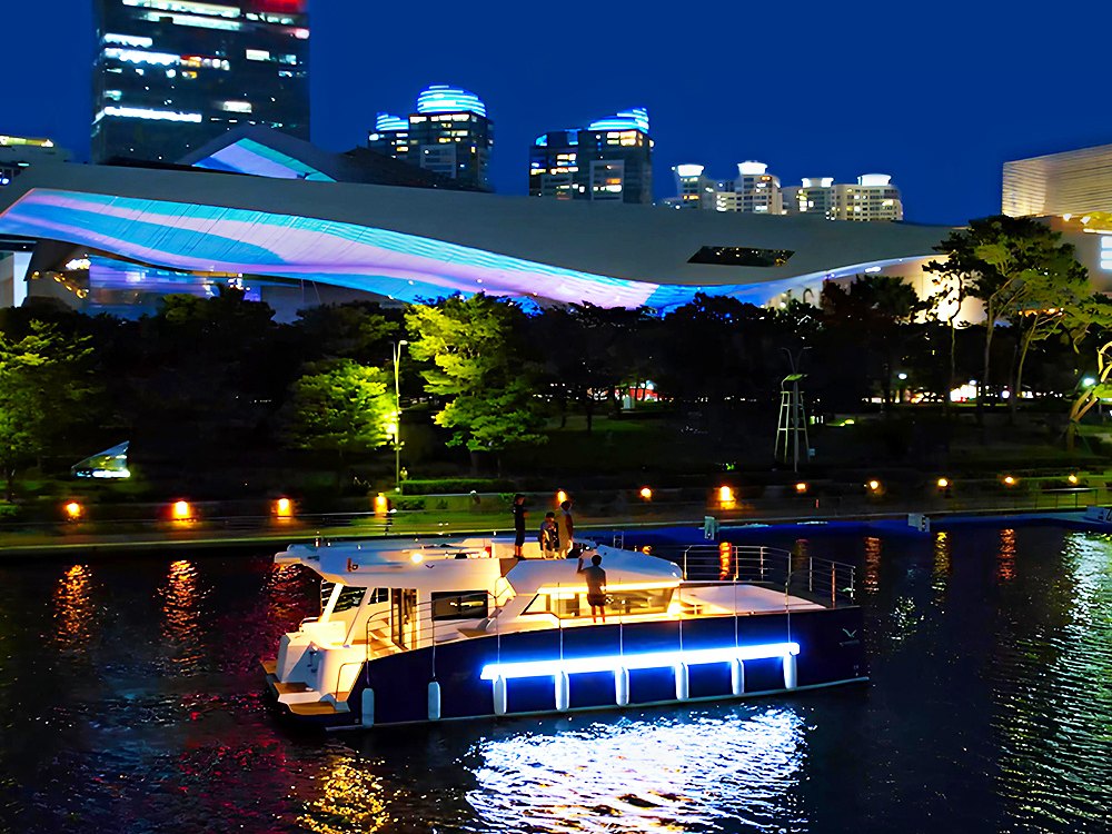 Night cruise passing the lights of Gwangan Bridge and Marine City