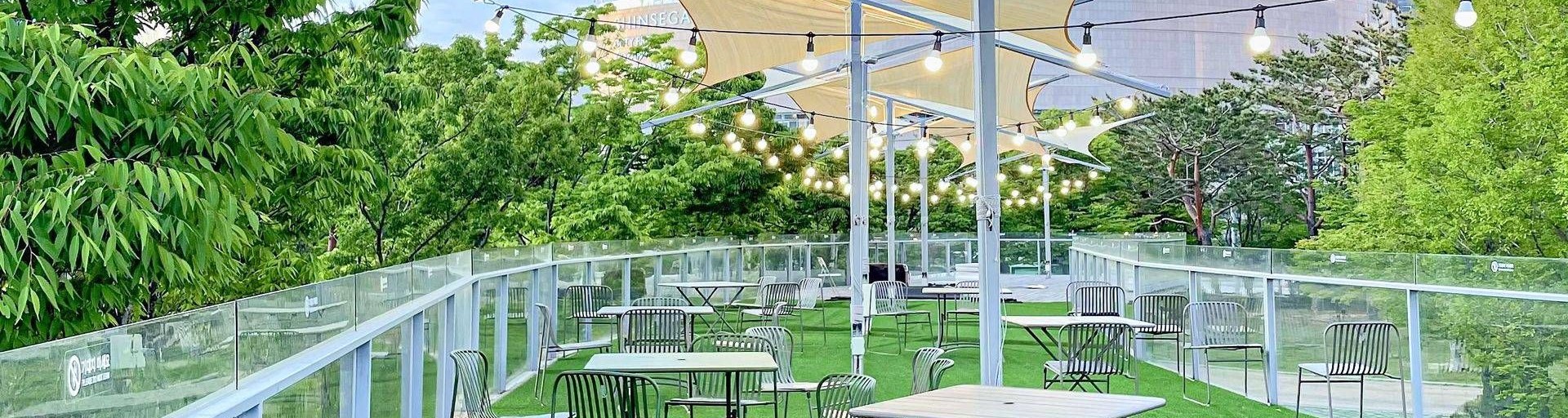 The ticket office rooftop with tables under white sunshades