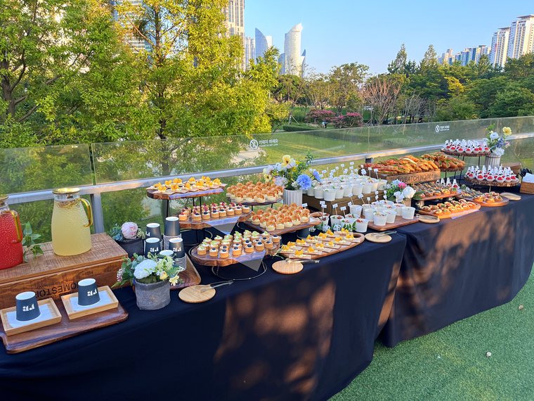 An outdoor event set up on the rooftop with Naru Park behind