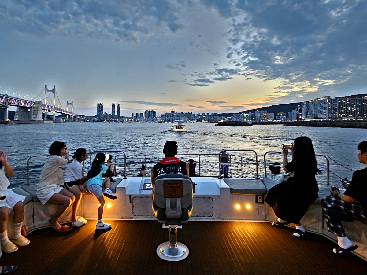 Group guests gathered on deck with the night view behind