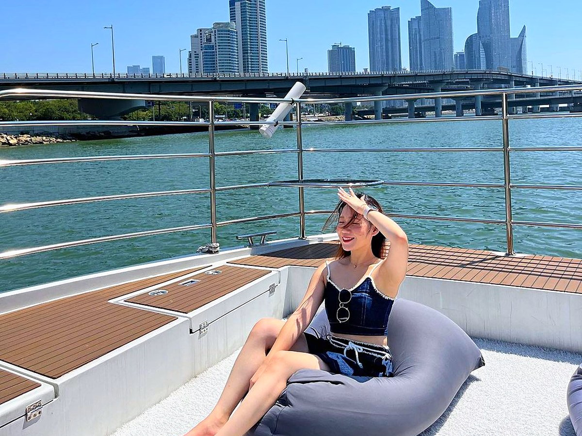 A guest leaning on a beanbag and looking out to sea