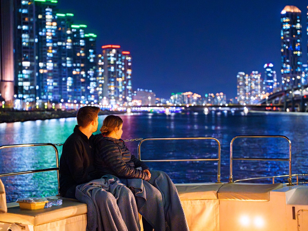 A couple looking at Marine City at night