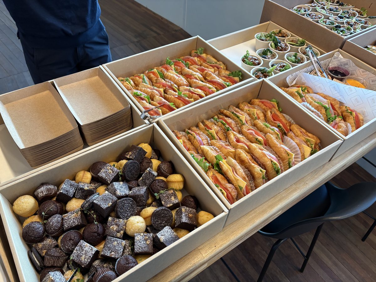Sandwiches, muffins and brownies in catering boxes