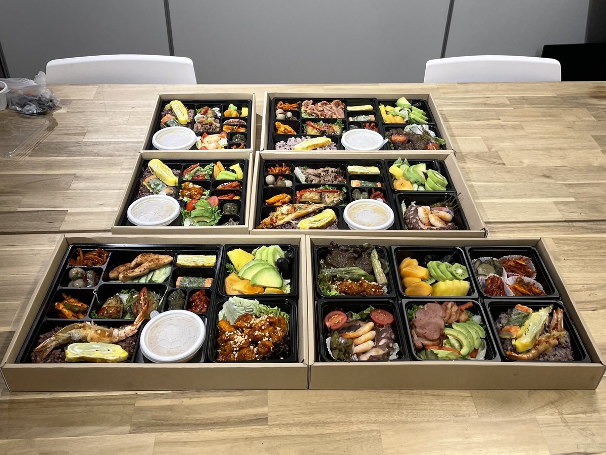 Korean lunch boxes laid out on a table