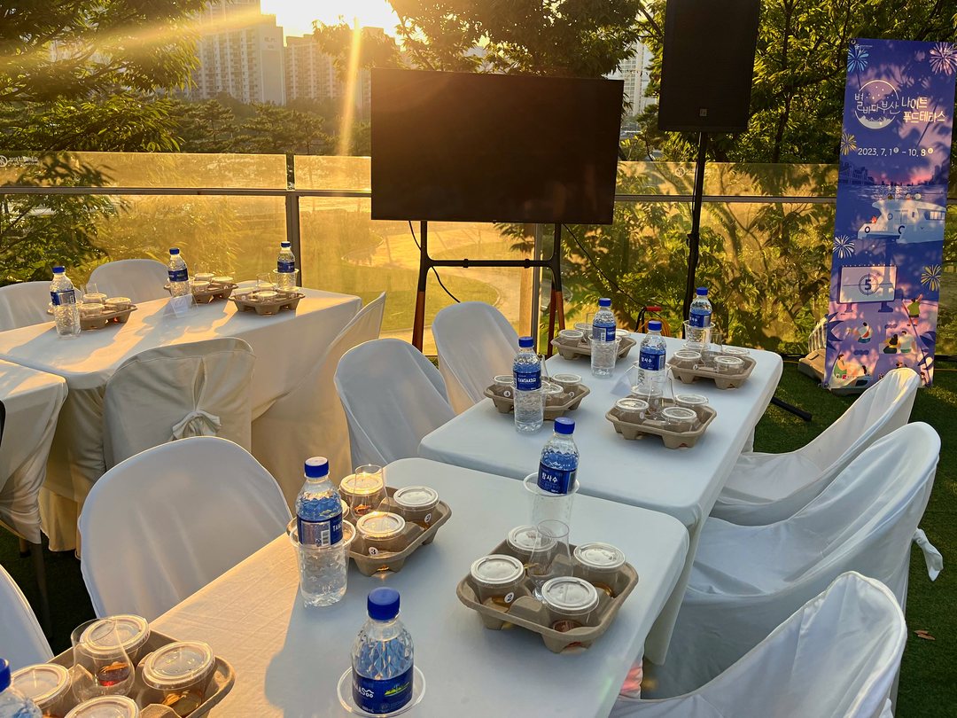 White table settings on the rooftop in the sunset glow