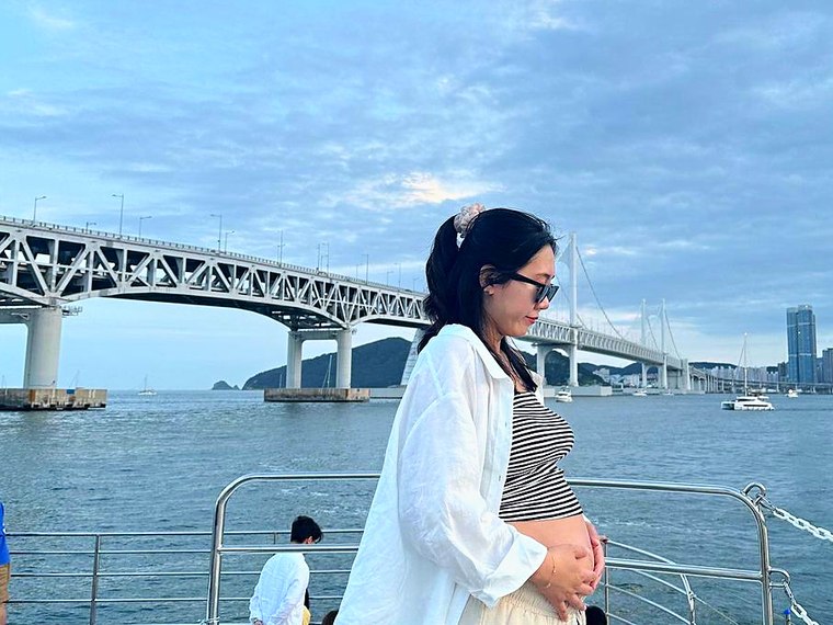 A guest on deck with Gwangan Bridge behind