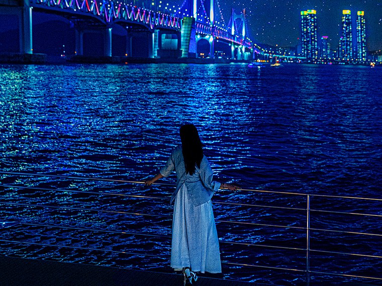 A guest watching the drone show over the night sea